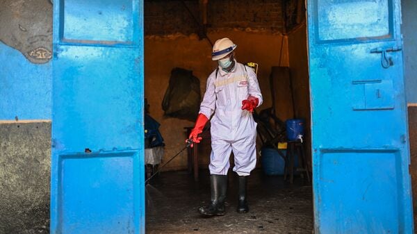 A sanitation worker from the Bunia city government sprays chlorine to disinfect the central market, as Ituri province continues to combat an Ebola outbreak, in Bunia, Congo, Saturday, May 23, 2026.
