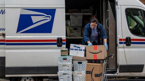 A United States Postal Service (USPS) worker delivers packages on Cyber Monday in San Francisco, California, US, on Monday, Nov. 27, 2023. Photographer: David Paul Morris/Bloomberg (Image for representative purpose)