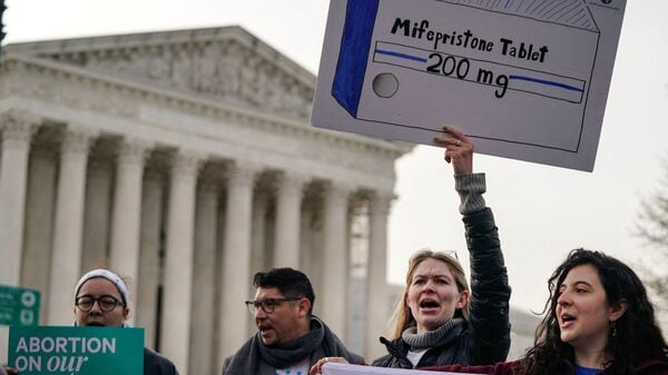 Abortion rights activists rally in front of the US Supreme Court on March 26, 2024, in Washington, DC. (Photo by Drew ANGERER / AFP)