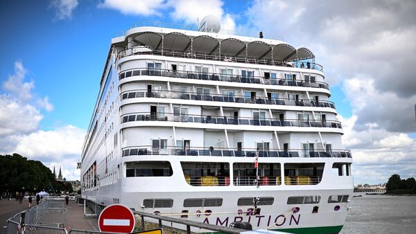 Passengers stand aboard the Bahamas-registered cruise ship Ambition after they were confined following the outbreak of a gastrointestinal illness onboard, at the Bordeaux port in Bordeaux, southwestern France on May 13, 2026 (Photo: AFP)