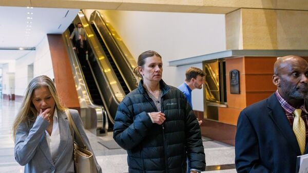 FILE image of Aimee Bock, founder and executive director of the nonprofit organization Feeding Our Future, with her attorney, Ken Udoibok, right.