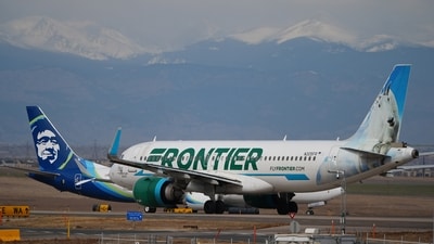 A Frontier Airlines jetliner waits for clearance to take off as high winds strafe Denver International Airport (AP)
