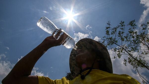 A man drinks water to revocer from the intense heat in Tegucigalpa City on May 12, 2026. Honduras has decided to shorten the school-day and hold virtual classes due to the high temperatures that could intensify due to El Nino phenomenon, official sources reported.