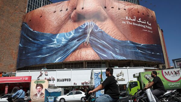 US-Iran News LIVE Updates: People ride past an anti-US billboard depicting U.S. President Donald Trump and the Strait of Hormuz, in Tehran, Iran