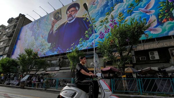 US-Iran Peace Deal LIVE updates: A motorbike drives past a billboard showing a portrait of the late Iranian President Ebrahim Raisi, who was killed in a helicopter crash in 2024, in downtown Tehran, Iran, Thursday, May 28, 2026. (AP Photo/Vahid Salemi)