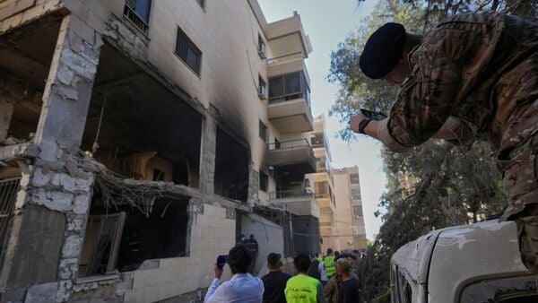 A Lebanese soldier takes pictures by his phone for a destroyed apartment that was hit in an Israeli airstrike in Choueifat town, southern Beirut, Lebanon, Thursday, May 28, 2026. (AP Photo/Hussein Malla)