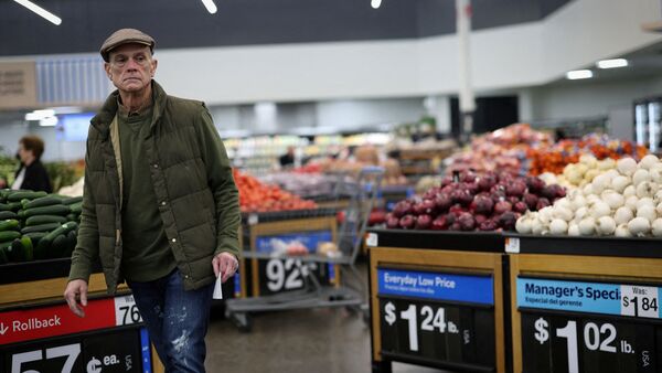 FILE PHOTO: A customer looks over produce at a Walmart Supercenter retail store in North Bergen, New Jersey, U.S., November 21, 2025.  REUTERS/Mike Segar/File Photo