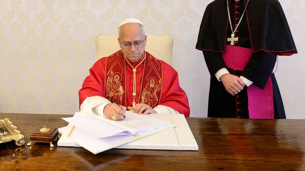 Pope Leo XIV signs Magnifica humanitas (Magnificent Humanity) at the Vatican, May 15, 2026. Vatican Media/­Handout via REUTERS