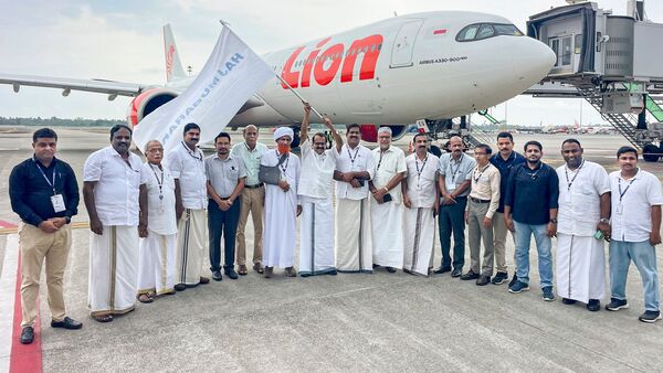 Union Minister George Kurien and others flag off the first short Hajj flight from Kochi, Kerala.