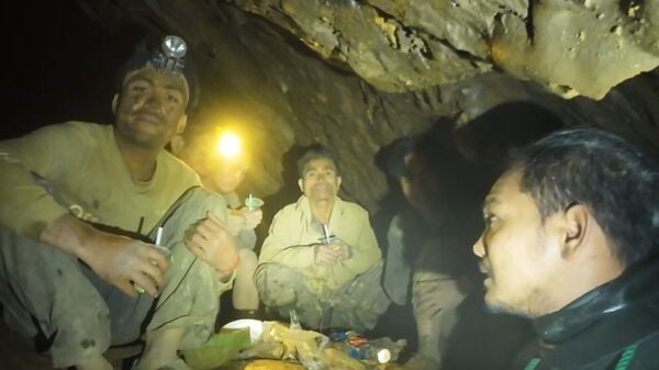 This image made from the video provided by Benz Norrased Palasing Seascout Diving shows rescuers speaking to the villagers who were trapped and found in a flooded cave in Xaisomboun province, Laos, Wednesday, May 27, 2026. AP/PTI