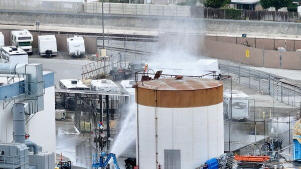 Water is sprayed on a tank that overheated at an aerospace plant in Garden Grove, Calif., Friday, May 22, 2026.  (Jeff Gritchen/The Orange County Register via AP)