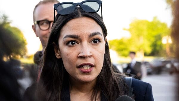 U.S. Rep. Alexandria Ocasio-Cortez (R-NY) speaks to media while arriving for votes in the House during a candlelight vigil in honor of National Police Week at the Capitol on May 12, 2026, in Washington, DC. Graeme Sloan/Getty Images/AFP