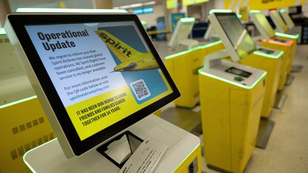 Self-check-in kiosks at Luis Munoz Marin International Airport display an 'Operational Update' message after Spirit Airlines announced it was ceasing operations early Saturday.