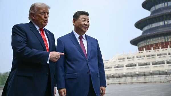 TOPSHOT - China's President Xi Jinping (R) and US President Donald Trump visit the Temple of Heaven in Beijing on May 14, 2026. Xi warned Trump that the issue of Taiwan could push their two countries into 'conflict' if mishandled, a stark opening salvo as a superpower summit set to tackle numerous thorny issues began in Beijing on May 14. (Photo by Brendan SMIALOWSKI / POOL / AFP)