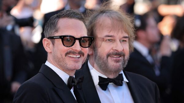 US actor Elijah Wood and New Zealand director, screenwriter and producer Peter Jackson arrive for the Opening Ceremony and the screening of the film 'La Venus electrique' (The Electric Kiss) at the 79th edition of the Cannes Film Festival in Cannes, southern France, on May 12, 2026.