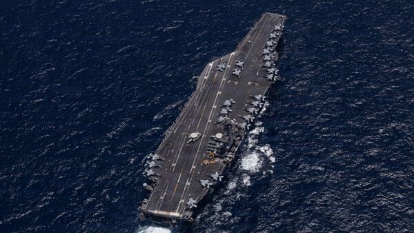 TOPSHOT - This US Navy handout photo released on May 7, 2026, by US Central Command Public Affairs shows Nimitz-class aircraft carrier USS George H.W. Bush (CVN 77) sailing in the Arabian Sea, on May 3, 2026. The United States was waiting on May 7 for Iran to respond to its latest proposed deal to end the war in the Middle East and to reopen the key shipping lane out of the Gulf. (Photo by US NAVY / AFP)