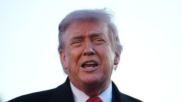 President Donald Trump speaks as he visits the Lincoln Memorial Reflecting Pool to see the new blue protective coating being applied as part of a renovation project, Thursday, May 7, 2026, in Washington. (AP Photo/Mark Schiefelbein)
