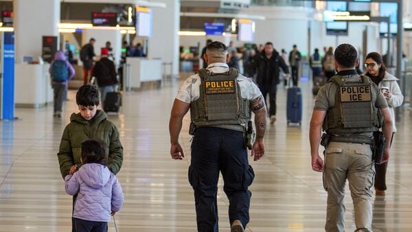 A file image of ICE agents walking through the airport