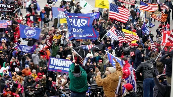 FILE - Violent protesters gather outside the U.S. Capitol, Jan 6, 2021. (AP Photo/Andrew Harnik, File)
