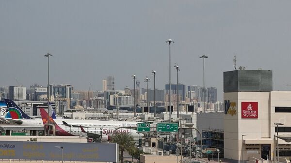 Passenger planes are parked at Dubai International Airport in Dubai on March 11, 2026. (AFP)