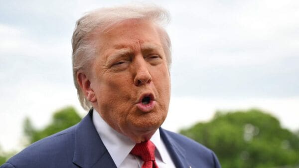 US President Donald Trump speaks to journalists as he makes his way to board Marine One before departing from the South Lawn of the White House in Washington, DC on May 8, 2026. Trump is traveling to Sterling, Virginia, where he will participate in a LIV Golf dinner. (Photo by Mandel NGAN / AFP)