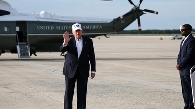 US President Donald Trump waves after stepping off Air Force One on May 15, 2026 at Joint Base Andrews, Maryland. (Getty Images via AFP)
