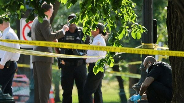 A U.S. Secret Service crime scene investigator works at the scene of an officer-involved shooting in Washington, D.C., U.S., May 4, 2026.