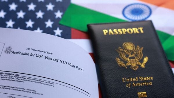 The US flag, mock passport and a US H-1B visa application form are seen in this illustration taken.