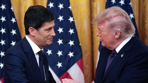 US President Donald Trump, right, and Kevin Warsh, chairman of the US Federal Reserve, shake hands during a swearing-in ceremony