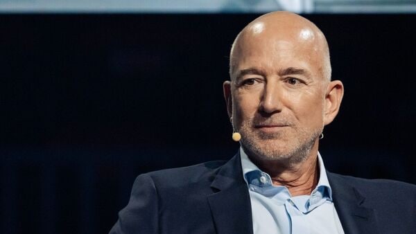 Jeff Bezos advocates for an experimental mindset, arguing that avoiding risk limits growth and potential.