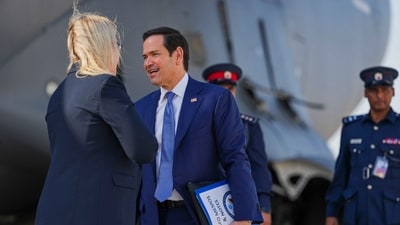 US Secretary of State Marco Rubio speaks with the US ambassador to Bahrain Stephanie Hallett before boarding a US Air Force C-17 Globemaster III transport aircraft after his visit to the Middle East to discuss the interim deal between the US and Iran with Arab Gulf allies, in Manama on June 25, 2026. (AFP)