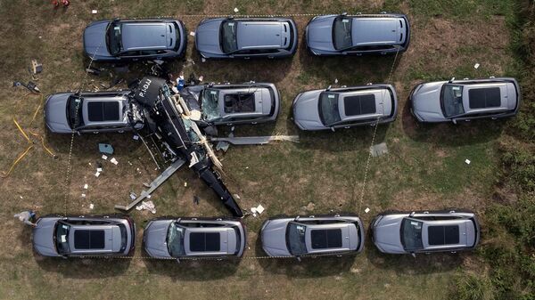 An aerial view shows the site of a helicopter crash in the Recreio dos Bandeirantes neighbourhood, in Rio de Janeiro, Brazil, on June 14, 2026. At least six people died in Brazil on June 14 after two helicopters crashed in western Rio de Janeiro, after a suspected mid-air collision, firefighters said. (Photo by Tercio TEIXEIRA / AFP)