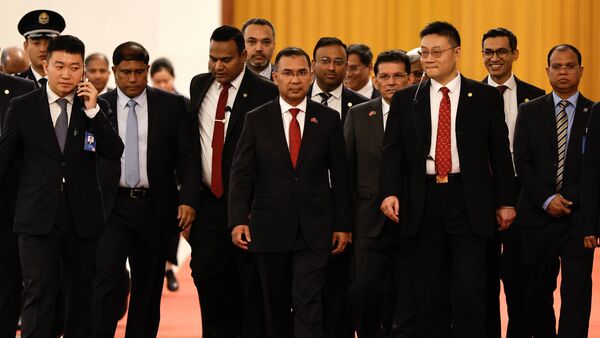 Bangladesh's Prime Minister Tarique Rahman, center, arrives for a meeting with Chinese President Xi Jinping at the Great Hall of the People, in Beijing, China Friday, June 26, 2026.