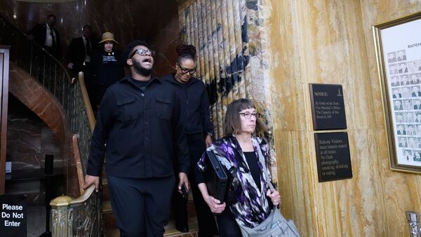 Members of the public react as they leave the Louisiana House chambers after a redistricting plan to eliminate a majority-Black congressional district, in response to a U.S. Supreme Court ruling, was passed in Baton Rouge, La., Thursday, May 28, 2026. (AP Photo/Gerald Herbert)