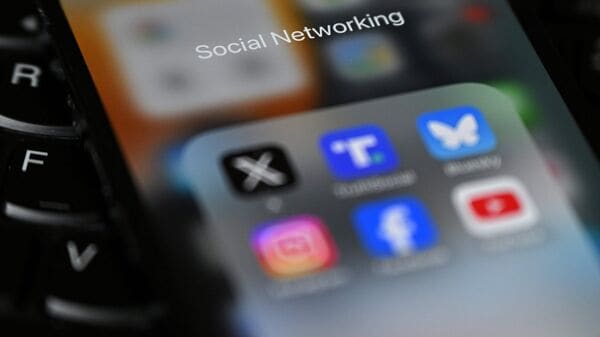 Photo illustration showing social networking apps displayed on a phone screen