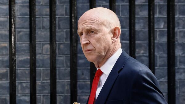 (FILES) Britain's Defence Secretary John Healey arrives at Downing Street to attend a cabinet meeting in central London on May 12, 2026. British Defence Secretary John Healey resigned on June 11, 2026, in a surprise move which he said was due to Prime Minister Keir Starmer and his finance ministry failing to commit sufficient resources to long-term defence plans. (Photo by Brook Mitchell / AFP)