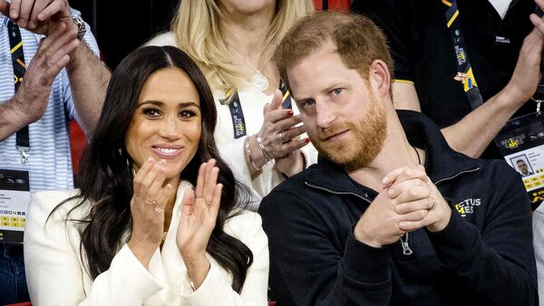 (FILES) The Duke and Duchess of Sussex, Prince Harry and his wife Meghan Markle visit the sitting volleyball section of the fifth edition of the Invictus Games in The Hague on April 17, 2022.  (Photo by Sem van der Wal / ANP / AFP) / Netherlands OUT