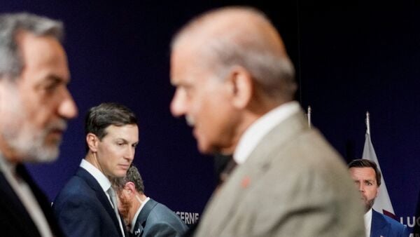 U.S. Vice President JD Vance looks on next to U.S. President Donald Trump's son-in-law Jared Kushner, as Iran's Foreign Minister Abbas Araqchi shakes hands with Pakistan's Prime Minister Shehbaz Sharif, before the start of a quadrilateral meeting between the U.S., Iran, Pakistan, and Qatar at the Lake Lucerne Summit, aimed at advancing a deal to end the Middle East conflict, at Buergenstock Resort Lake Lucerne, near Stansstad, Switzerland, June 21, 2026. REUTERS/Nathan Howard/Pool      TPX IMAGES OF THE DAY