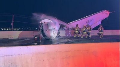 Firefighters were seen dousing the crashed plane in Laredo, Texas, in a video shared by the local police department. (Facebook/Laredo Police Department)