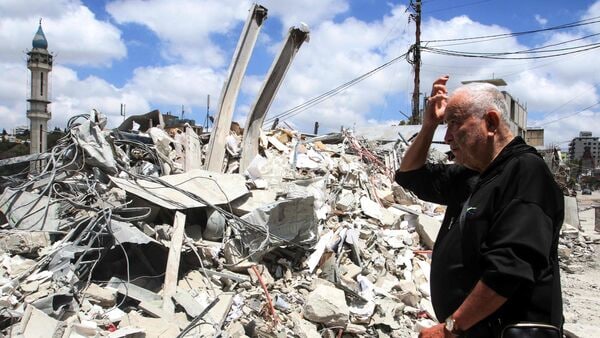 A man looks at the damage as residents displaced by the fighting return to Nabatieh in southern Lebanon on 15 June 2026. Israel's defence minister said that Israeli forces would remain in Lebanon, Syria and Gaza indefinitely, hours after the United States and Iran agreed to end the Middle East war, including in Lebanon. (Photo by Mahmoud Zayyat / AFP)