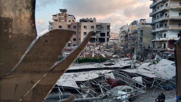 Iran US War News LIVE: A destroyed building that was hit in an Israeli airstrike is seen through a shattered window of the Jabal Amel Hospital, in Lebanon