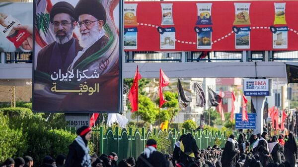 A billboard depicting Iran's late and current supreme leaders Ali Khamenei and his son Mojtaba Khamenei is displayed in Beirut's southern suburbs on June 26, 2026. (Photo by ibrahim AMRO / AFP)