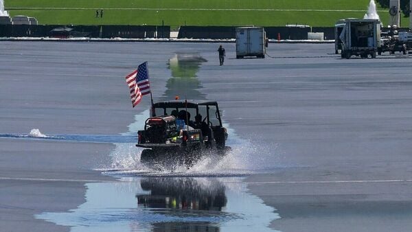 Workers drive through as water flows into the Lincoln Memorial Reflecting Pool, ahead of the United States 250th anniversary, Thursday, June 4, 2026, in Washington. (AP Photo/Rod Lamkey, Jr.)