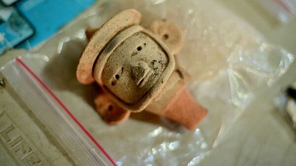 Latest news on June 20, 2026: A view shows an anthropomorphic whistle face handled by archaeologists working at an archaeological site in Coatepec, Veracruz, Mexico. Mexican archaeologists have discovered the remains of a structure and a sculpture bearing features similar to those of the Maya culture and other characteristics described as never before seen in the eastern state of Veracruz.