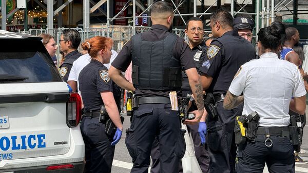 New York Police Department officers gather after alleged gunfire was heard in Times Square, in New York City, U.S., June 18, 2026.  Picture taken with a phone. REUTERS/Andrew Hofstetter