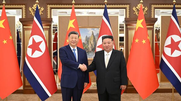 In this photo released by Xinhua News Agency, Chinese President Xi Jinping, left, and North Korean leader Kim Jong Un shake hands for a photo at Kumsusan State Guesthouse in Pyongyang, Monday, June 8, 2026. (Xie Huanchi/Xinhua via AP)