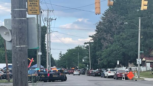 Police officers work at the scene of a shooting near a festival in Toledo, Ohio on Saturday, June 6, 2026. (WTVG via AP)