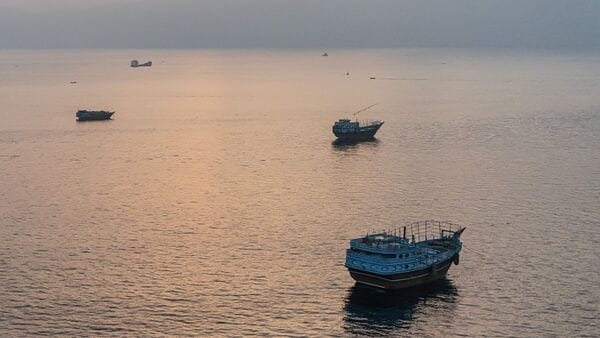 This aerial photograph shows boats anchored off Oman's northern Musandam Peninsula near the Strait of Hormuz on June 27, 2026. (Photo by AFP) /