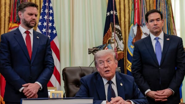 US President Donald Trump speaks in the Oval Office, with Vice President JD Vance and Secretary of State Marco Rubio standing behind him, at the White House in Washington.