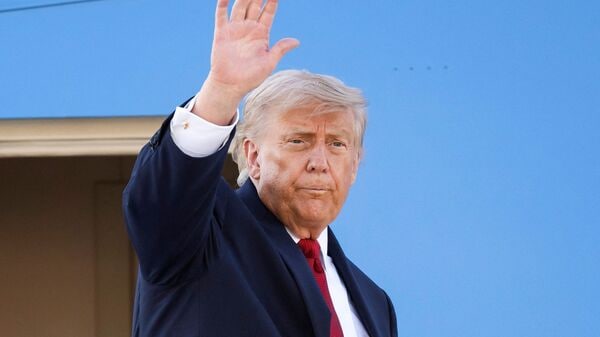 US President Donald Trump gestures as he boards Air Force One at Geneva Airport en route to Versailles after attending the G7 summit, in Geneva on June 17, 2026. (Photo by MARTIAL TREZZINI / POOL / AFP)